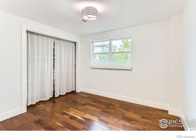 2550 Woodstock Pl, Boulder, CO 80305 - unfurnished bedroom featuring dark wood-style flooring and baseboards