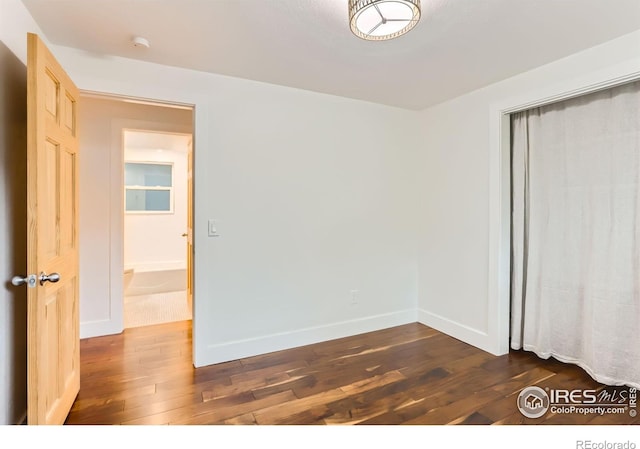 2550 Woodstock Pl, Boulder, CO 80305 - unfurnished bedroom featuring dark wood-style floors, baseboards, and a closet