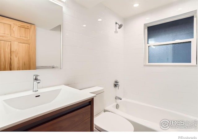 2550 Woodstock Pl, Boulder, CO 80305 - bathroom featuring toilet, washtub / shower combination, vanity, and tile walls
