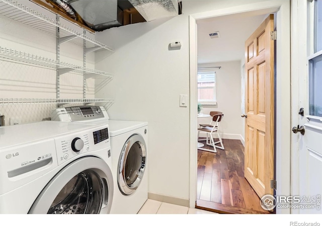 2550 Woodstock Pl, Boulder, CO 80305 - clothes washing area with separate washer and dryer, baseboards, and light wood finished floors
