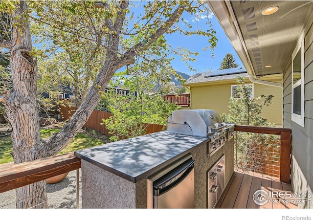 2550 Woodstock Pl, Boulder, CO 80305 - deck featuring an outdoor kitchen, fence, and area for grilling