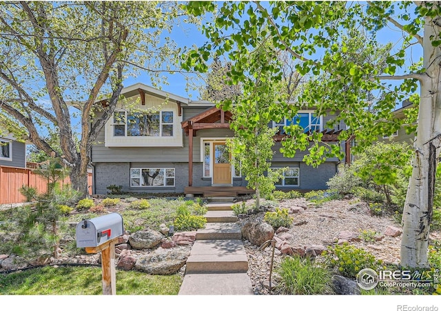 2550 Woodstock Pl, Boulder, CO 80305 - view of front of home featuring brick siding and fence