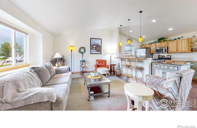 living area with vaulted ceiling and recessed lighting
