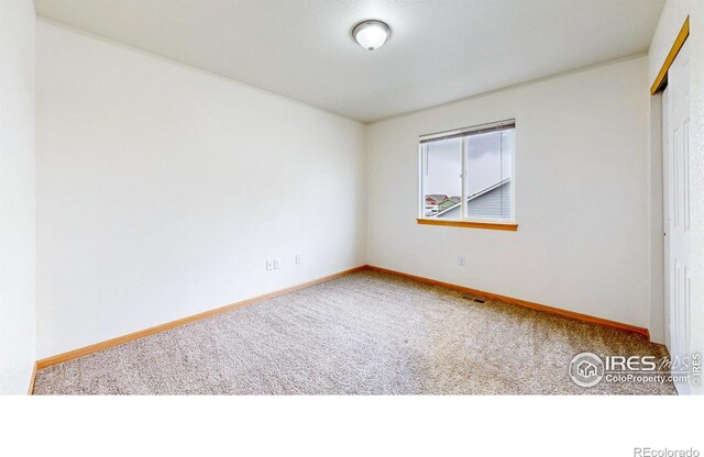 unfurnished bedroom featuring carpet flooring, a closet, and baseboards