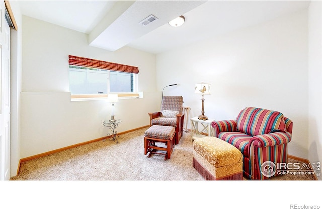 living area featuring carpet and baseboards
