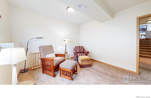 sitting room with carpet floors, baseboards, and stairway