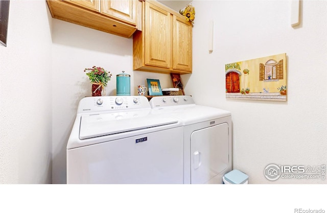 laundry area featuring independent washer and dryer and cabinet space