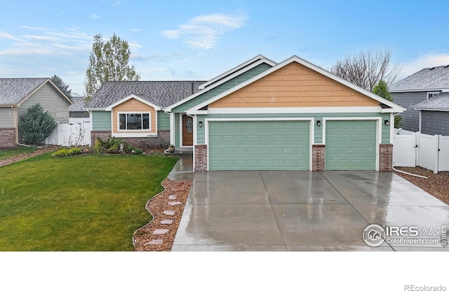 3705 Mount Spalding St, Wellington, CO 80549 - view of front of property featuring a garage, driveway, brick siding, and a gate