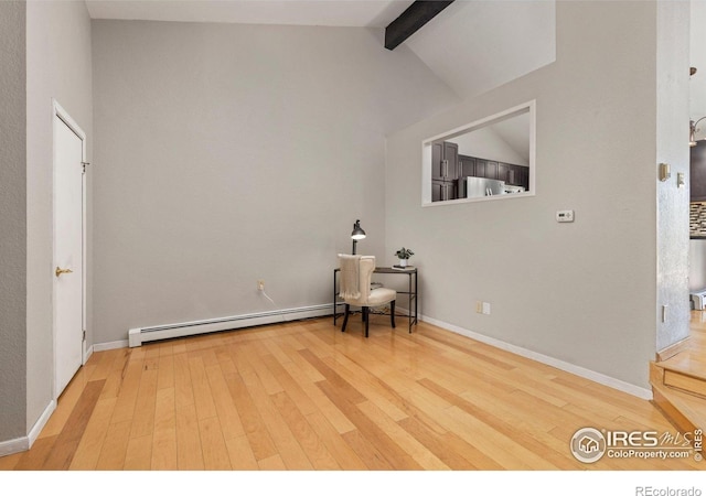 unfurnished room with a baseboard radiator, wood finished floors, and baseboards