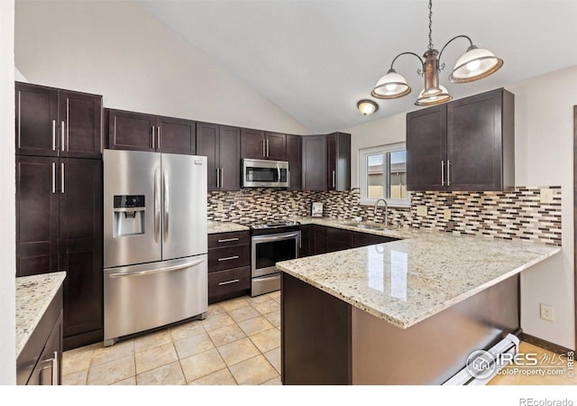 kitchen with appliances with stainless steel finishes, a peninsula, lofted ceiling, dark brown cabinets, and backsplash