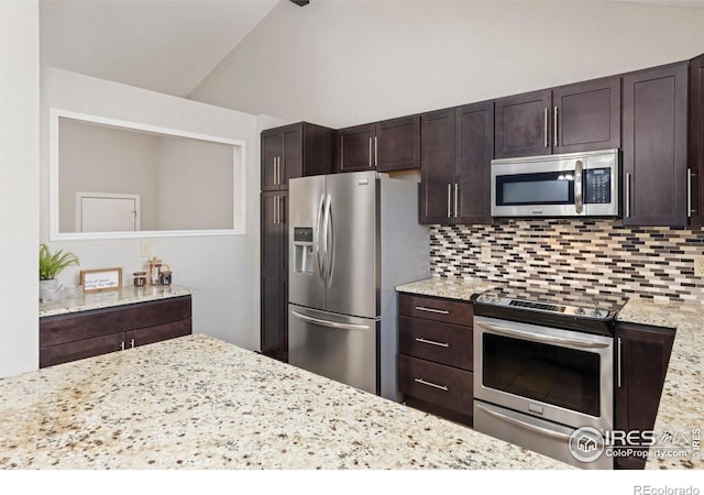 kitchen with stainless steel appliances, dark brown cabinets, backsplash, and vaulted ceiling