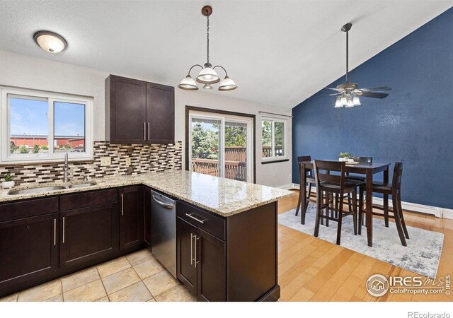 kitchen featuring a sink, stainless steel dishwasher, lofted ceiling, decorative backsplash, and a ceiling fan