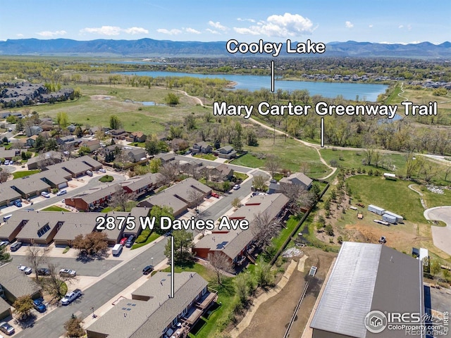 view of property location with a water and mountain view and nearby suburban area