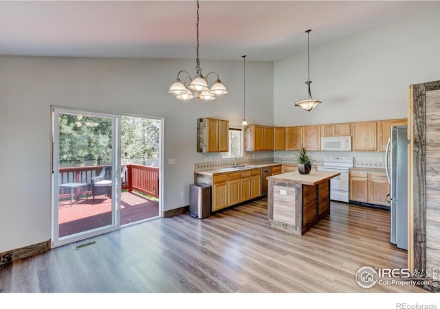 3530 Homestead Dr, Mead, CO 80542 - kitchen with white appliances, high vaulted ceiling, light countertops, a kitchen island, and a sink