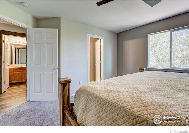 3530 Homestead Dr, Mead, CO 80542 - bedroom with light colored carpet, ensuite bath, a sink, and ceiling fan