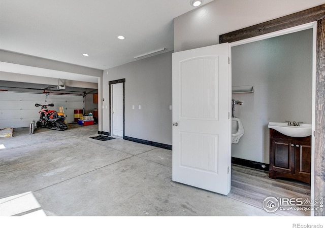 3530 Homestead Dr, Mead, CO 80542 - garage with a sink, a garage door opener, baseboards, and recessed lighting