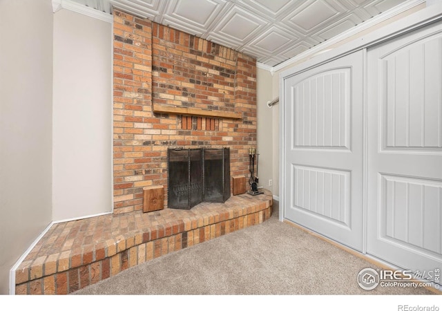 unfurnished living room with a brick fireplace, an ornate ceiling, and carpet floors