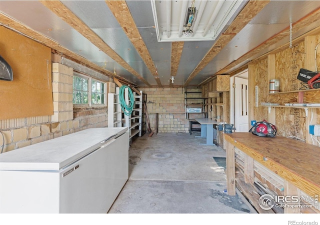 misc room featuring a workshop area and concrete floors