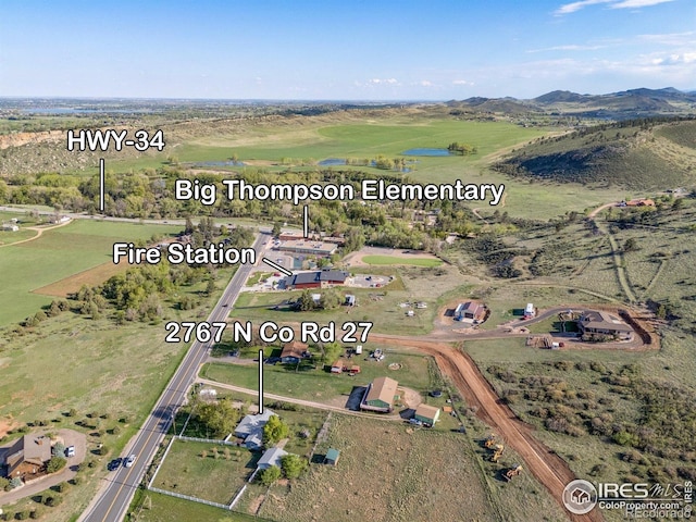 aerial view of property and surrounding area with a mountain backdrop