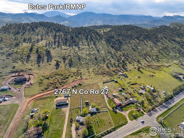 aerial view of property and surrounding area with a mountain backdrop