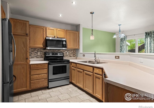 2002 E 102nd Cir, Thornton, CO 80229 - kitchen with stainless steel appliances, a sink, decorative backsplash, pendant lighting, and light countertops
