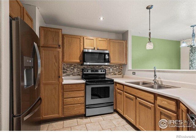 2002 E 102nd Cir, Thornton, CO 80229 - kitchen featuring stainless steel appliances, a sink, tasteful backsplash, light countertops, and recessed lighting