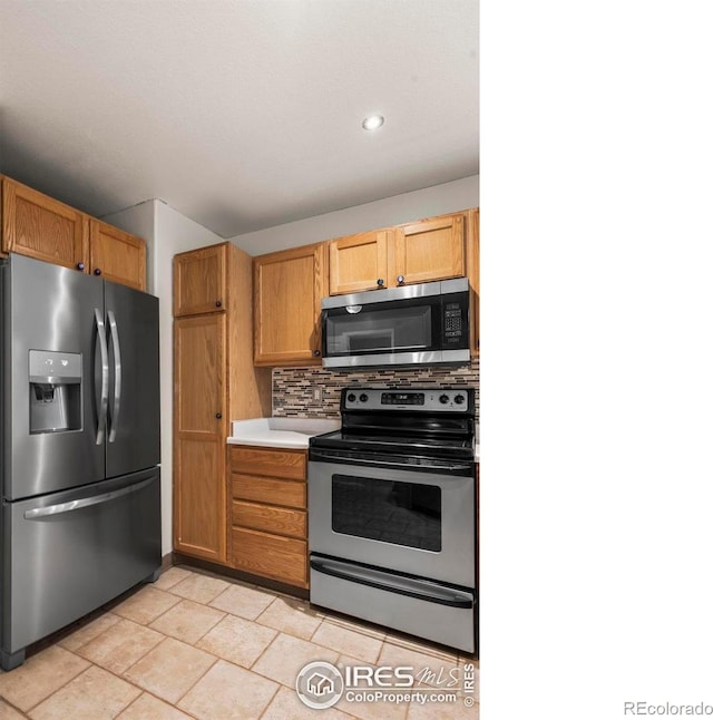 2002 E 102nd Cir, Thornton, CO 80229 - kitchen with stainless steel appliances, light countertops, backsplash, and recessed lighting