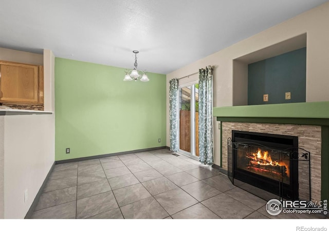 2002 E 102nd Cir, Thornton, CO 80229 - unfurnished living room with a glass covered fireplace, a chandelier, light tile patterned floors, and baseboards