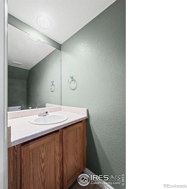 2002 E 102nd Cir, Thornton, CO 80229 - bathroom with a textured wall and vanity