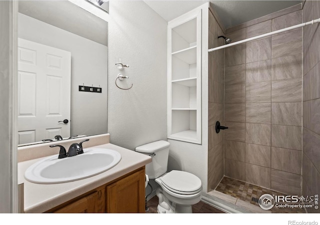 2002 E 102nd Cir, Thornton, CO 80229 - bathroom featuring a tile shower, vanity, and toilet