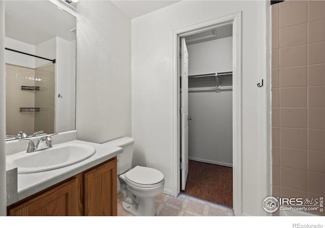 2002 E 102nd Cir, Thornton, CO 80229 - bathroom with tile patterned floors, toilet, vanity, a shower, and a spacious closet