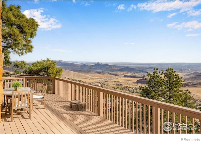 6300 Feldspar Ct, Bellvue, CO 80512 - wooden deck with outdoor dining space and a mountain view