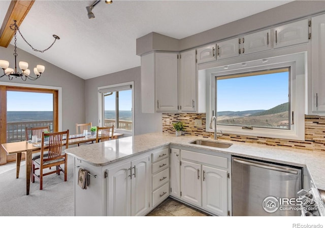 6300 Feldspar Ct, Bellvue, CO 80512 - kitchen with stainless steel dishwasher, lofted ceiling, backsplash, white cabinets, and a peninsula