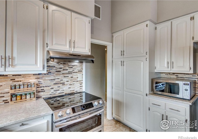 6300 Feldspar Ct, Bellvue, CO 80512 - kitchen featuring stainless steel appliances, under cabinet range hood, white cabinets, and backsplash