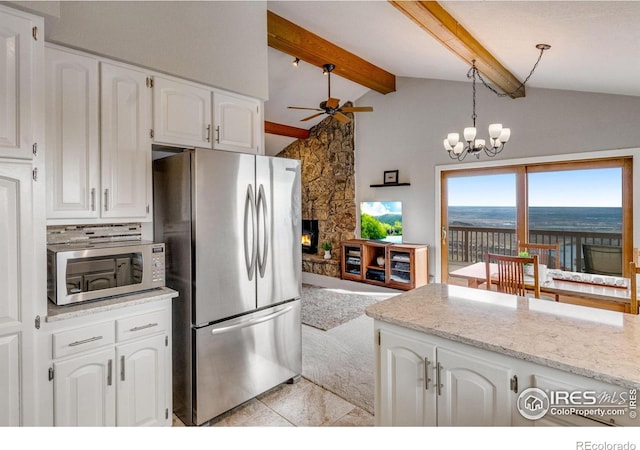 6300 Feldspar Ct, Bellvue, CO 80512 - kitchen featuring stainless steel appliances, ceiling fan, white cabinetry, decorative light fixtures, and a chandelier