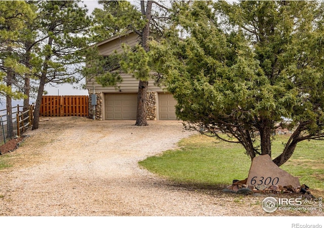 6300 Feldspar Ct, Bellvue, CO 80512 - view of front of home featuring stone siding, dirt driveway, and an attached garage
