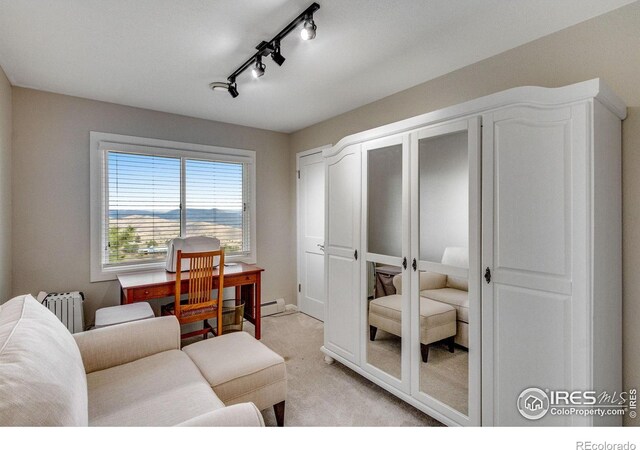 6300 Feldspar Ct, Bellvue, CO 80512 - living room featuring radiator, light carpet, a baseboard heating unit, and track lighting