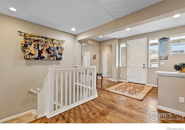 entrance foyer featuring wood finished floors, baseboards, and recessed lighting