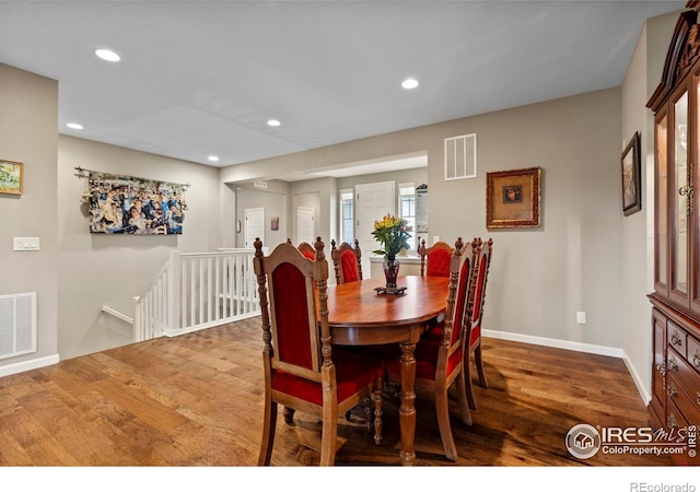 dining space with wood finished floors, recessed lighting, and baseboards