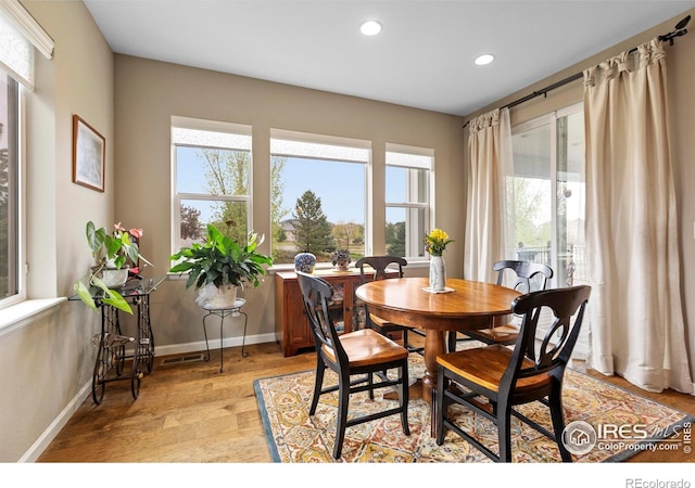 dining room featuring recessed lighting, baseboards, and light wood finished floors