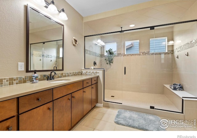 full bathroom with a shower stall, tile patterned flooring, and vanity