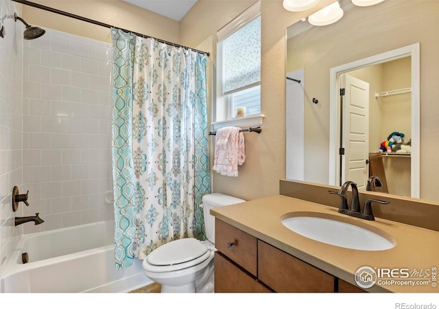 bathroom with toilet, shower / bath combination with curtain, and vanity