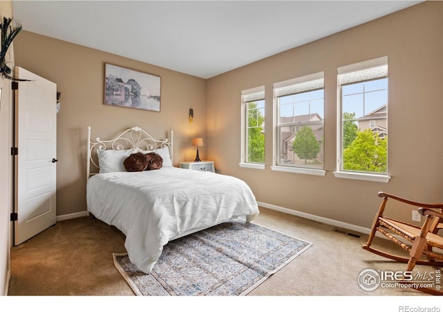 carpeted bedroom featuring baseboards