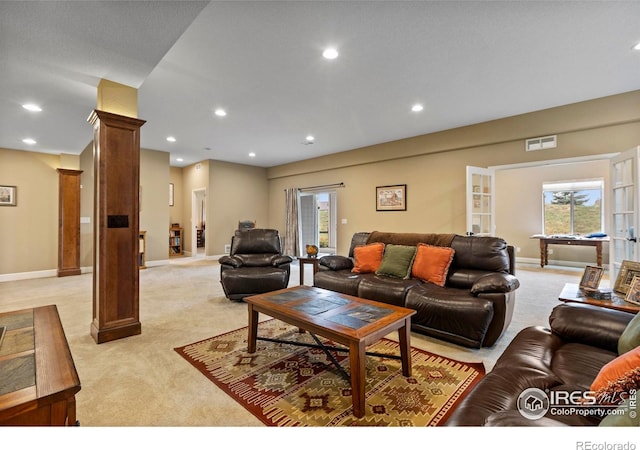living area with ornate columns, light colored carpet, baseboards, and recessed lighting