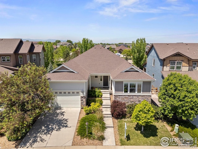 2551 Cub Lake Ct, Loveland, CO 80538 - view of front of property featuring a residential view, stone siding, driveway, a garage, and a shingled roof