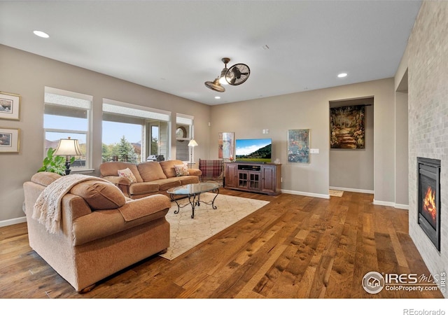 2551 Cub Lake Ct, Loveland, CO 80538 - living area with a fireplace, wood finished floors, recessed lighting, and baseboards