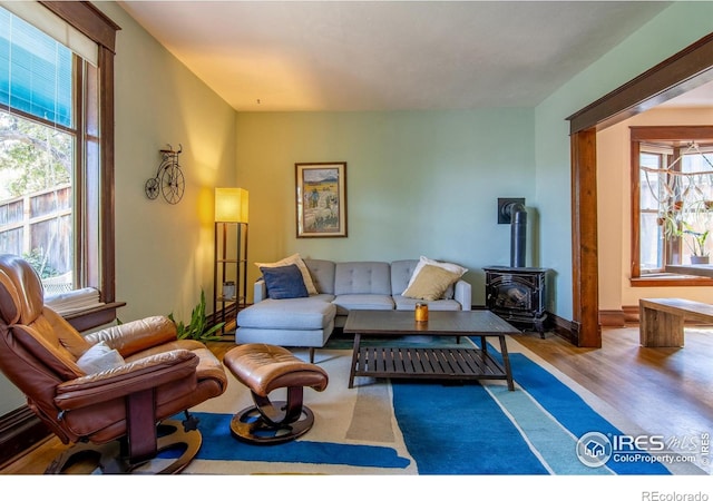 2645 5th St, Boulder, CO 80304 - living area with plenty of natural light, a wood stove, and wood finished floors