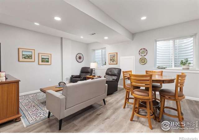 living room with light wood-type flooring, recessed lighting, and baseboards