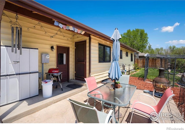 view of patio / terrace featuring fence, outdoor dining space, and grilling area