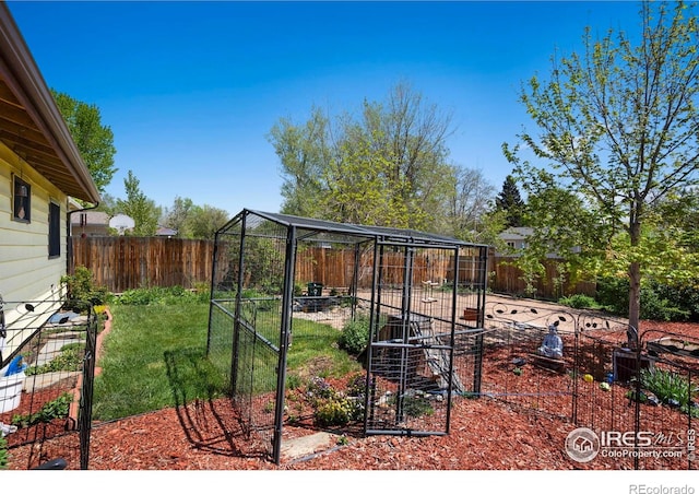 fenced backyard featuring an outdoor structure